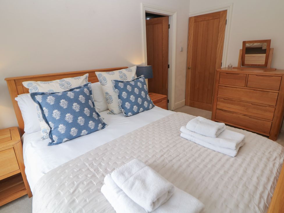 A bedroom with a bed and dresser at Lion House in Ashbourne