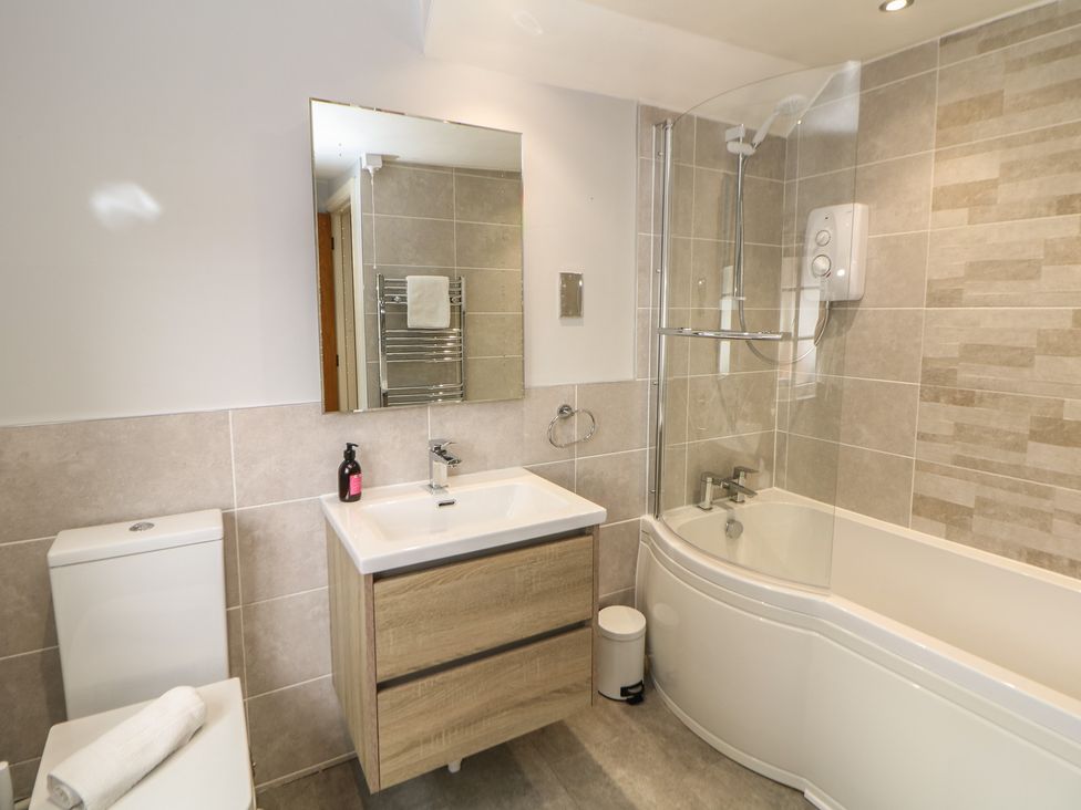 A bathroom with a sink, toilet, and shower at Lion House in Ashbourne