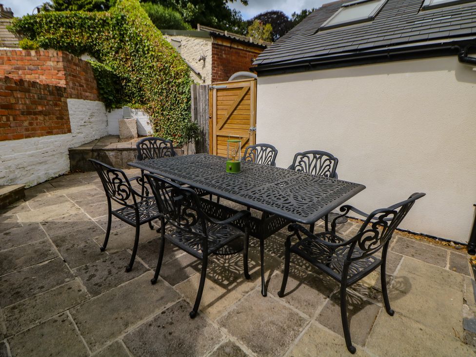 A patio area with a table and chairs at Lion House in Ashbourne