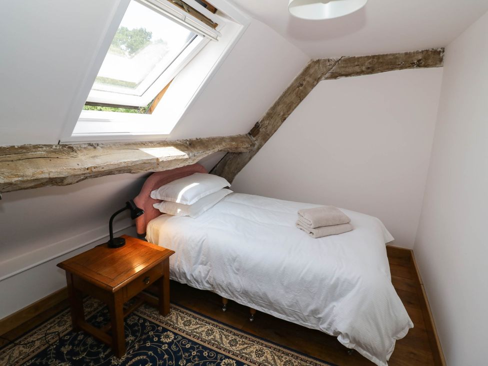 A bedroom with a bed and a nightstand at Netherend Barn Colwall Green near Great Malvern