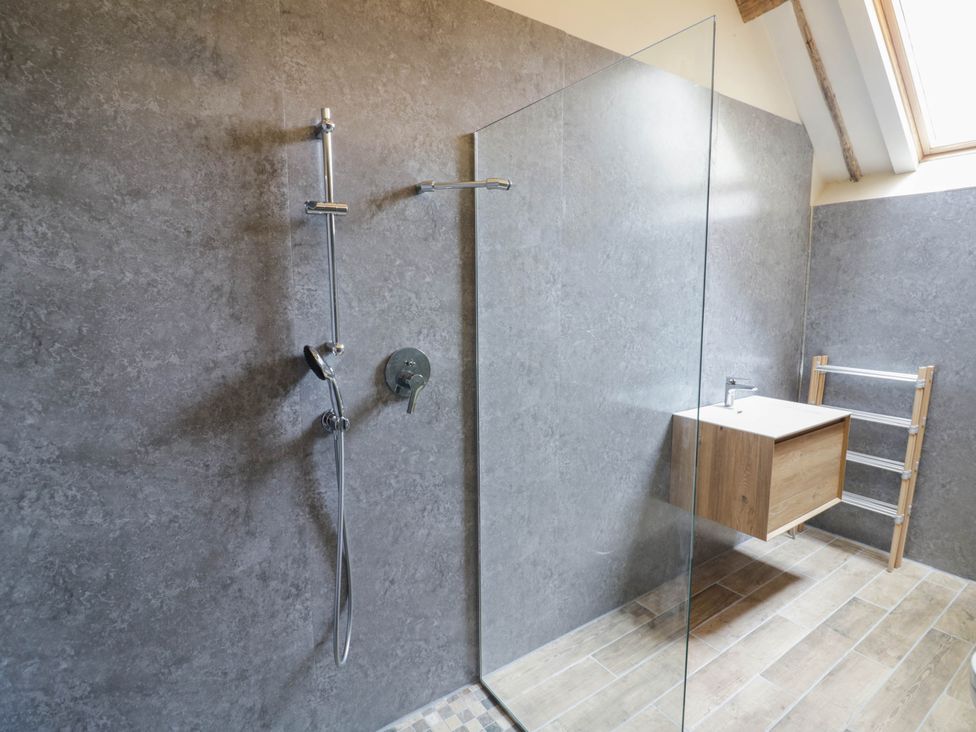 A bathroom with a shower and vanity unit at Netherend Barn in Colwall Green near Great Malvern