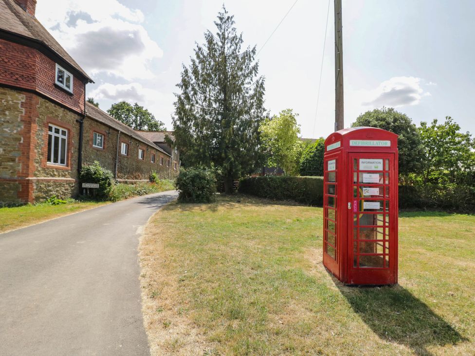 A telephone box and grass beside a road at Netherend Barn Colwall Green near Great Malvern