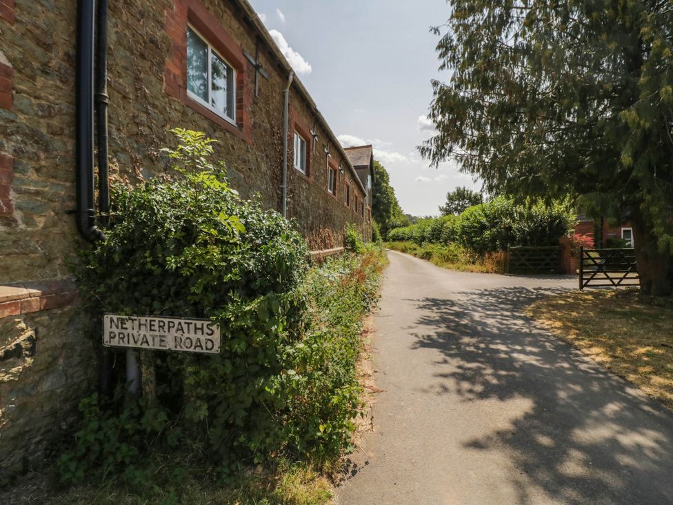 A private road sign near a stone wall at Netherend Barn Colwall Green near Great Malvern