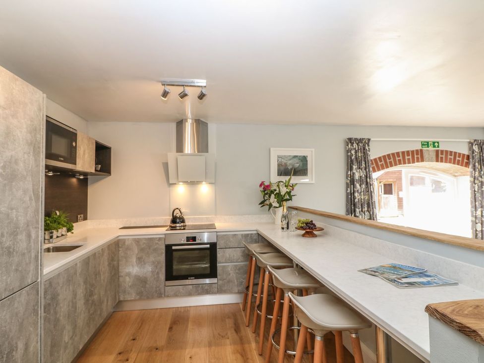 A kitchen with a counter and stools at Dexter in Treverva near Constantine