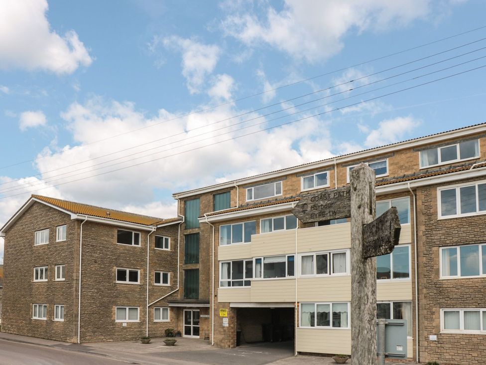A building with windows and a signpost at Flat 30 Bridport