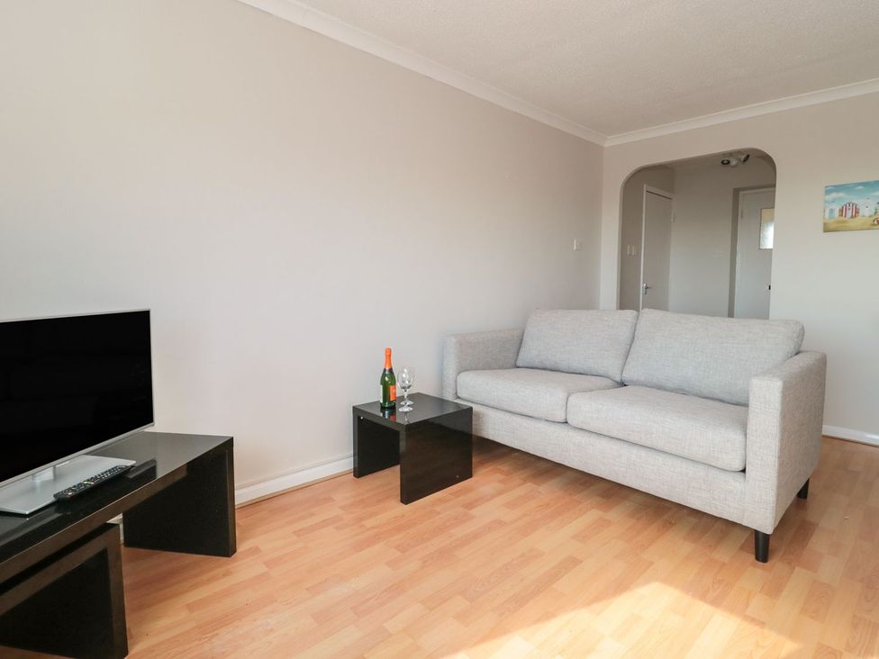 A living room with a sofa and a television at Flat 30 in Bridport