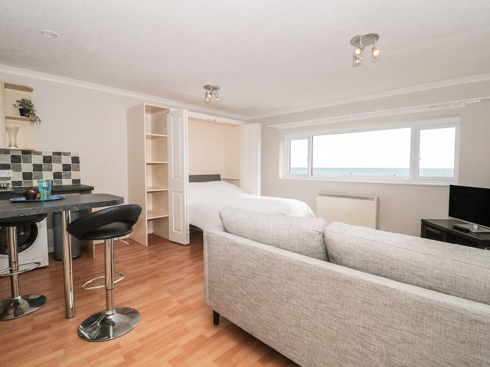 A studio with a bed and kitchen area at Flat 30 in Bridport