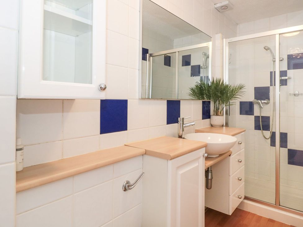 A bathroom with a sink and shower at Flat 30 in Bridport