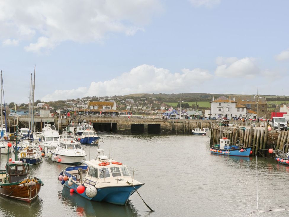 A harbor scene with boats and a pier at Flat 30 in Bridport