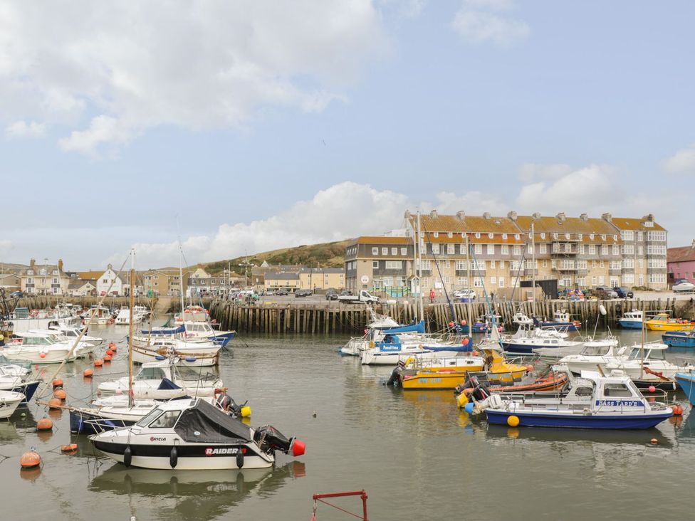 A harbor with boats and buildings at Flat 30 Bridport