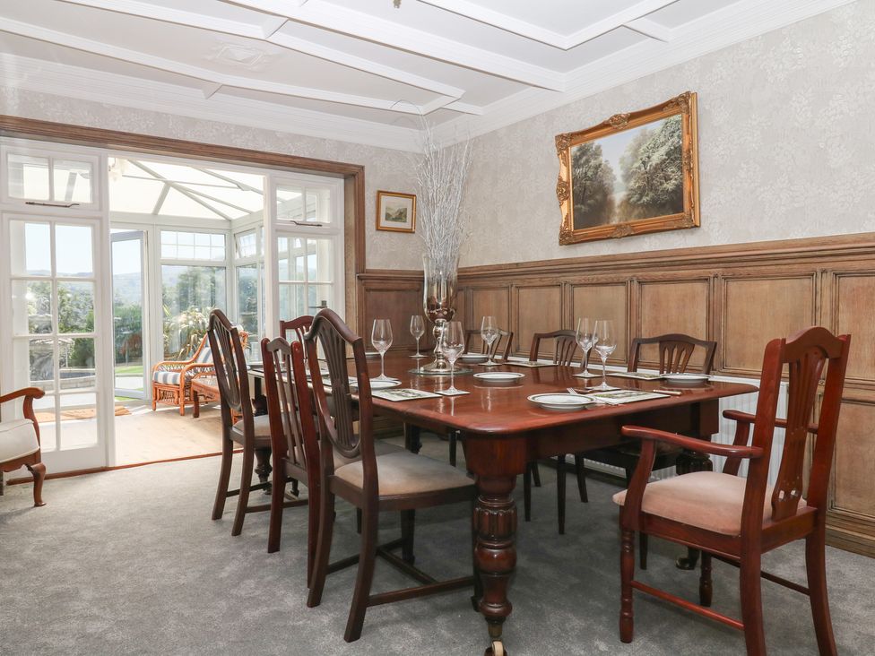 A dining room with a table set for dinner at The White House in Okehampton