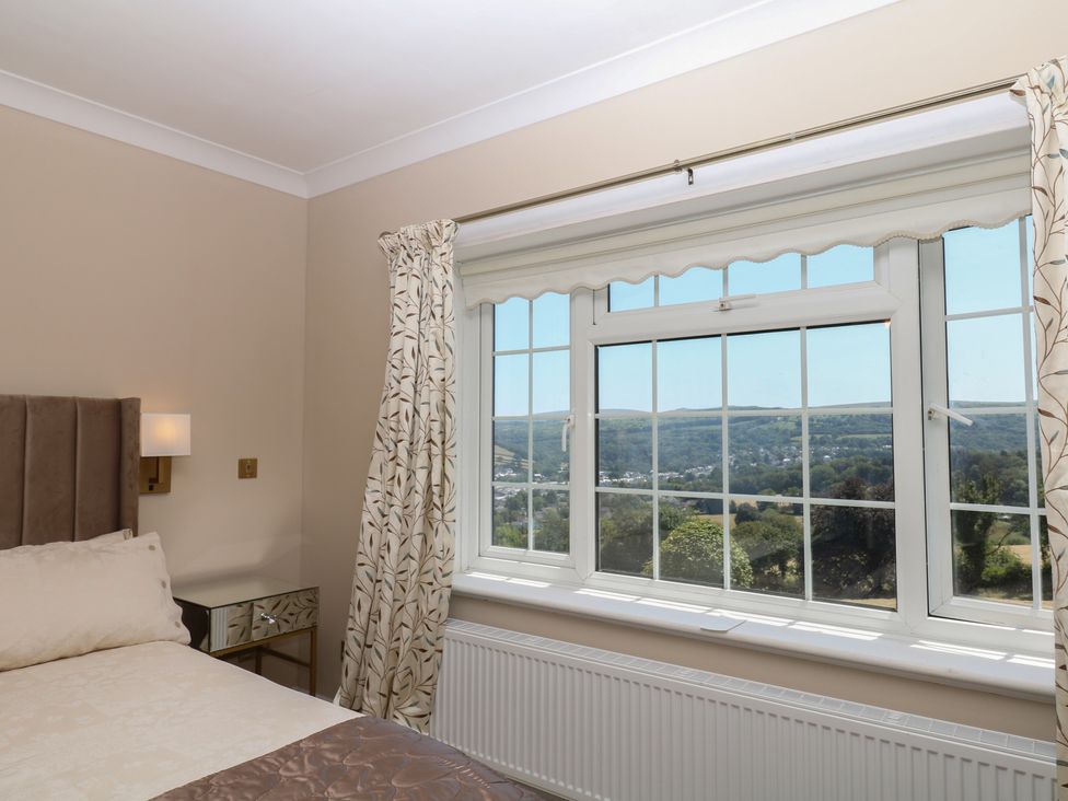 A bedroom with a window showing a view at The White House in Okehampton