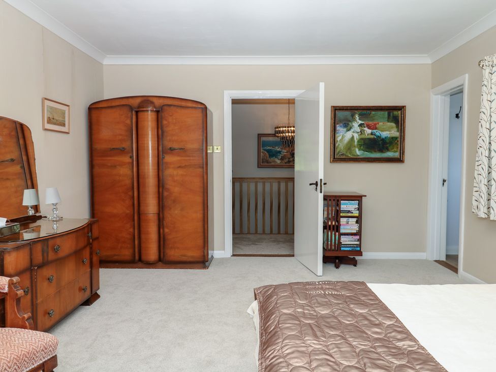 A bedroom with a wardrobe and dressing table at The White House in Okehampton