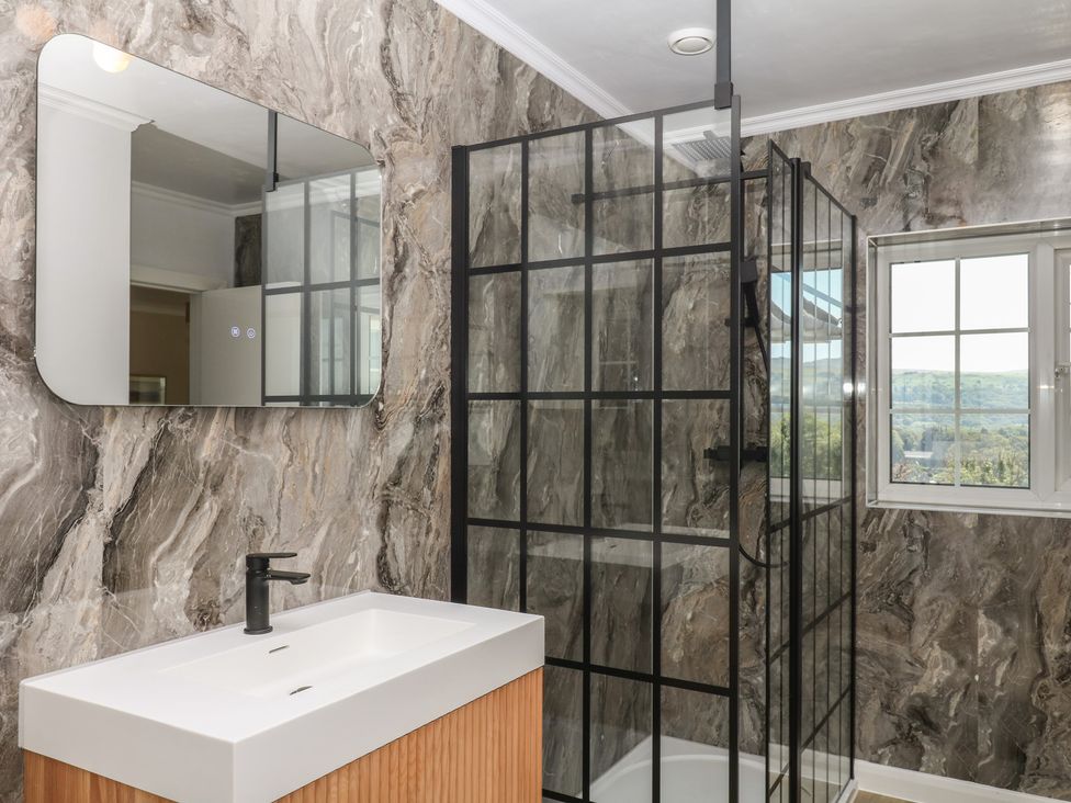A bathroom with a sink and shower at The White House in Okehampton