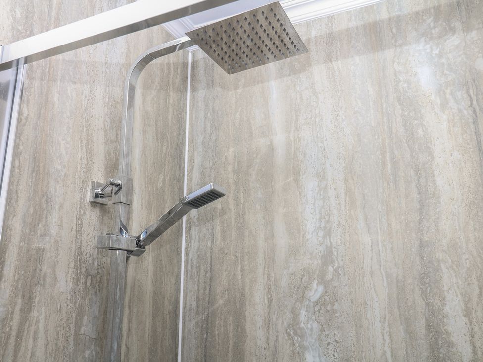 A shower installation with a shower head and handle at The White House in Okehampton