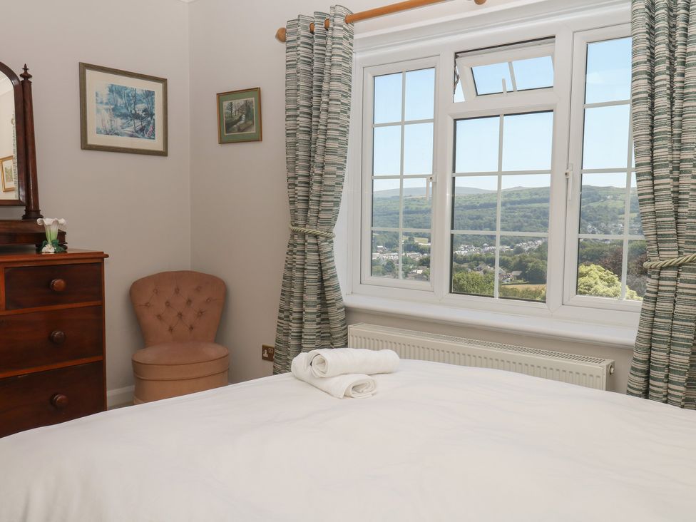A bedroom with a bed and window at The White House in Okehampton