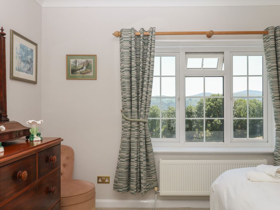 A bedroom with a window and curtains at The White House in Okehampton