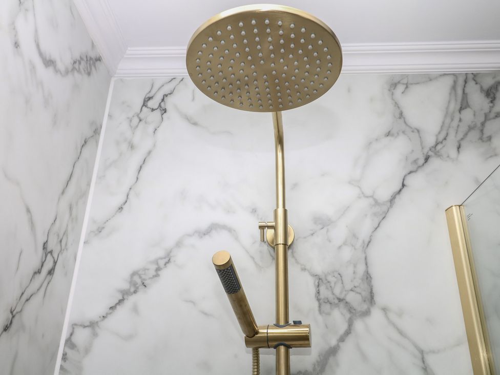 A shower head and fixtures in a bathroom at The White House in Okehampton