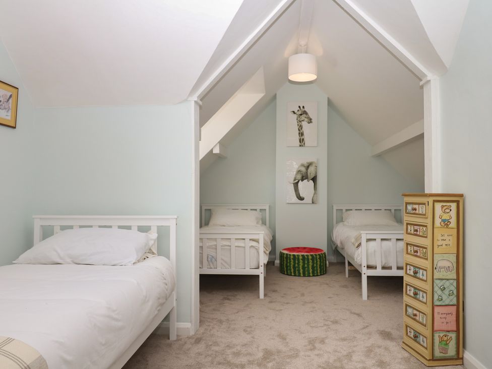 A bedroom with two beds and wall art at The White House in Okehampton