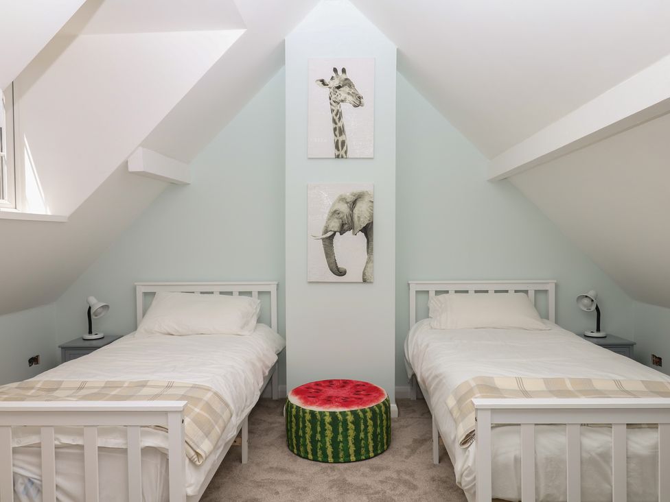 A bedroom with two beds and animal artwork at The White House in Okehampton
