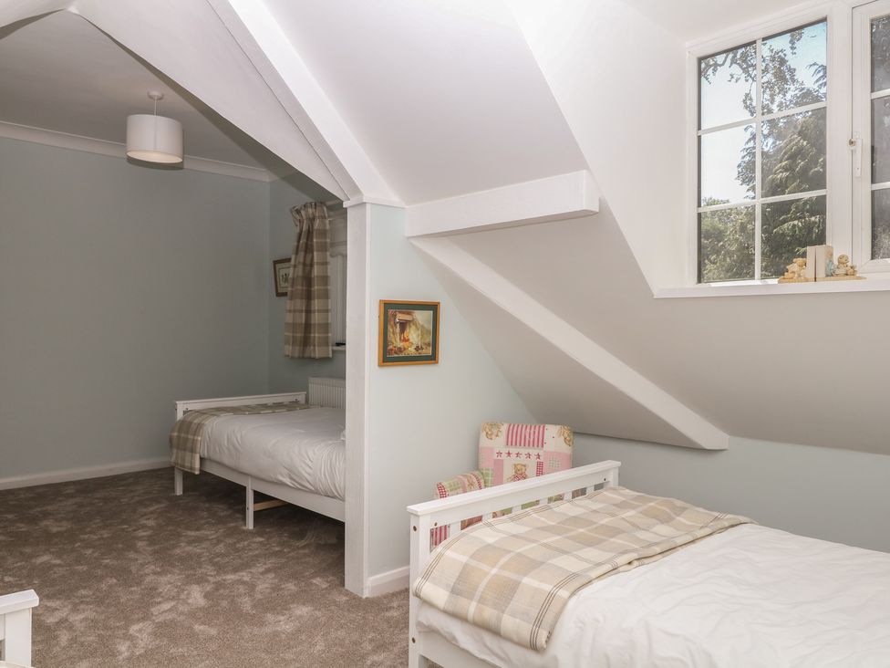 A bedroom with two beds and a window at The White House in Okehampton