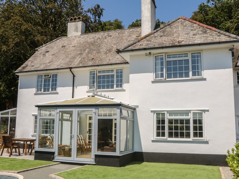 An outdoor view of a house with a conservatory at The White House in Okehampton