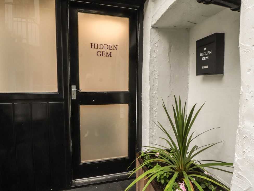 An entrance door with a nameplate at Hidden Gem