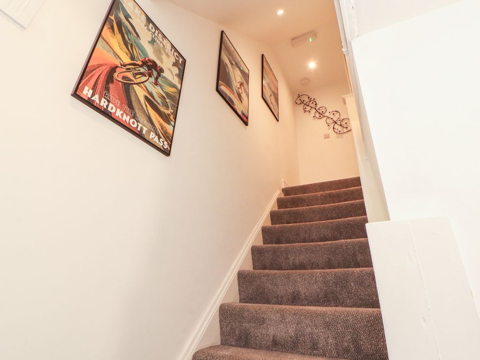 A staircase with posters on the wall at Hidden Gem in 
