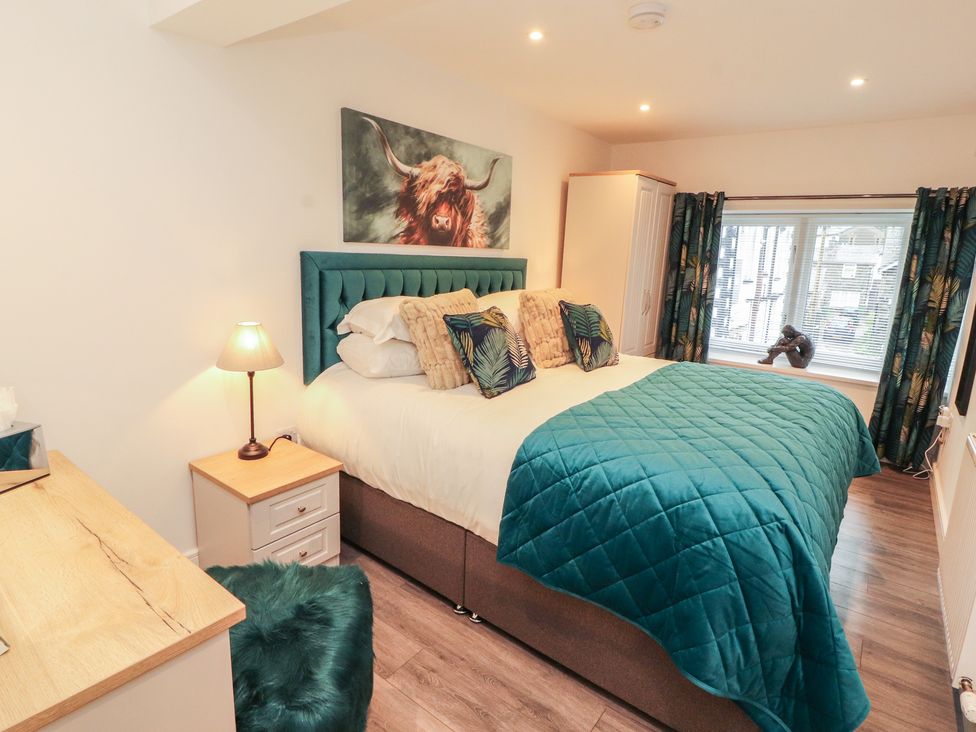 A bedroom with a bed and nightstand at Hidden Gem