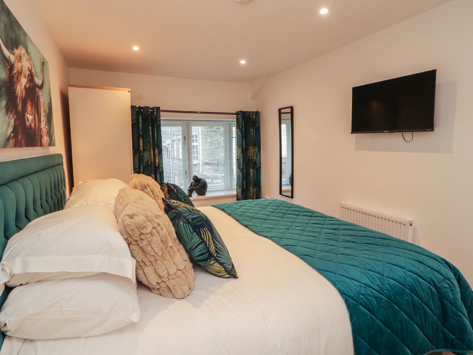 A bedroom with a bed and television at Hidden Gem in 