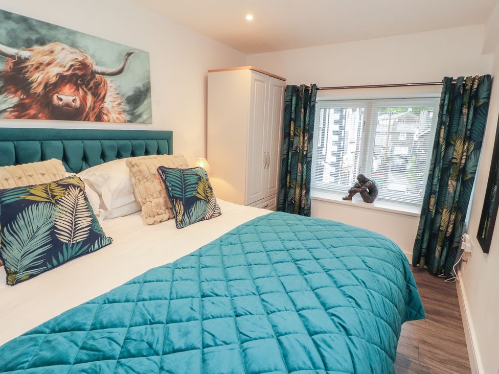 A bedroom with a bed and a wardrobe at Hidden Gem