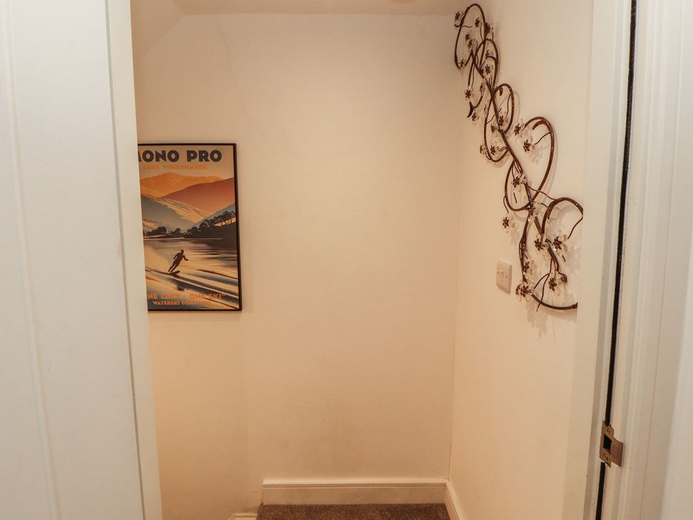 A hallway with a poster and wall decoration at Hidden Gem