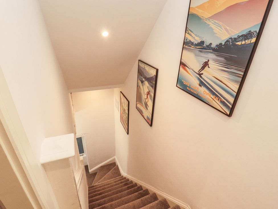 A staircase with framed art on the wall at Hidden Gem