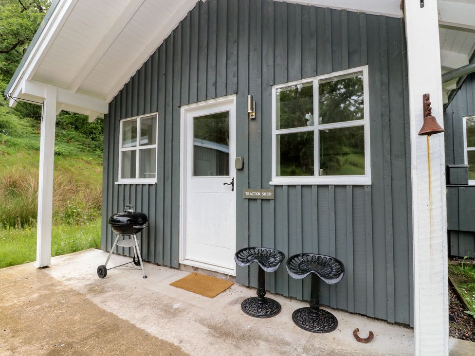 An outdoor area with a door and windows at The Tractor Shed in Killin