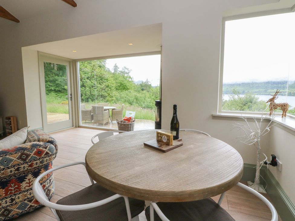 A dining area with a circular table and chairs at The Tractor Shed in Killin