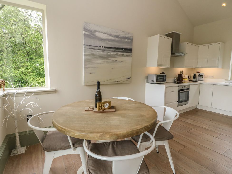 A kitchen with a round table and chairs at The Tractor Shed in Killin