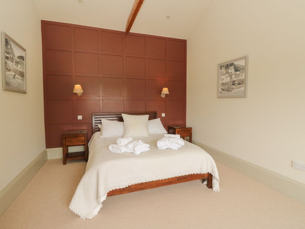 A bedroom with a bed and side tables at The Tractor Shed in Killin