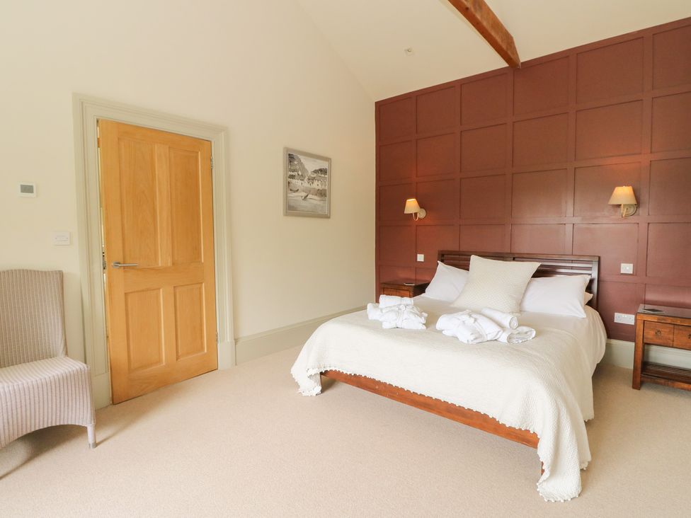 A bedroom with a bed and bedside tables at The Tractor Shed in Killin