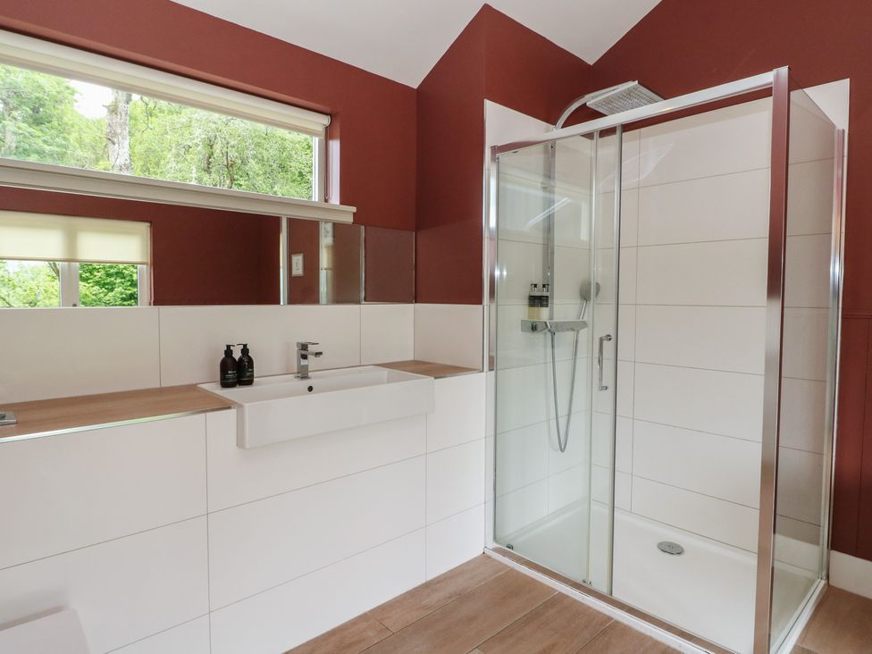 A bathroom with a sink and shower at The Tractor Shed in Killin