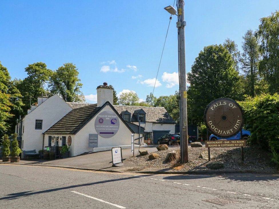 A building with a sign for Falls of Dochart Inn in Killin