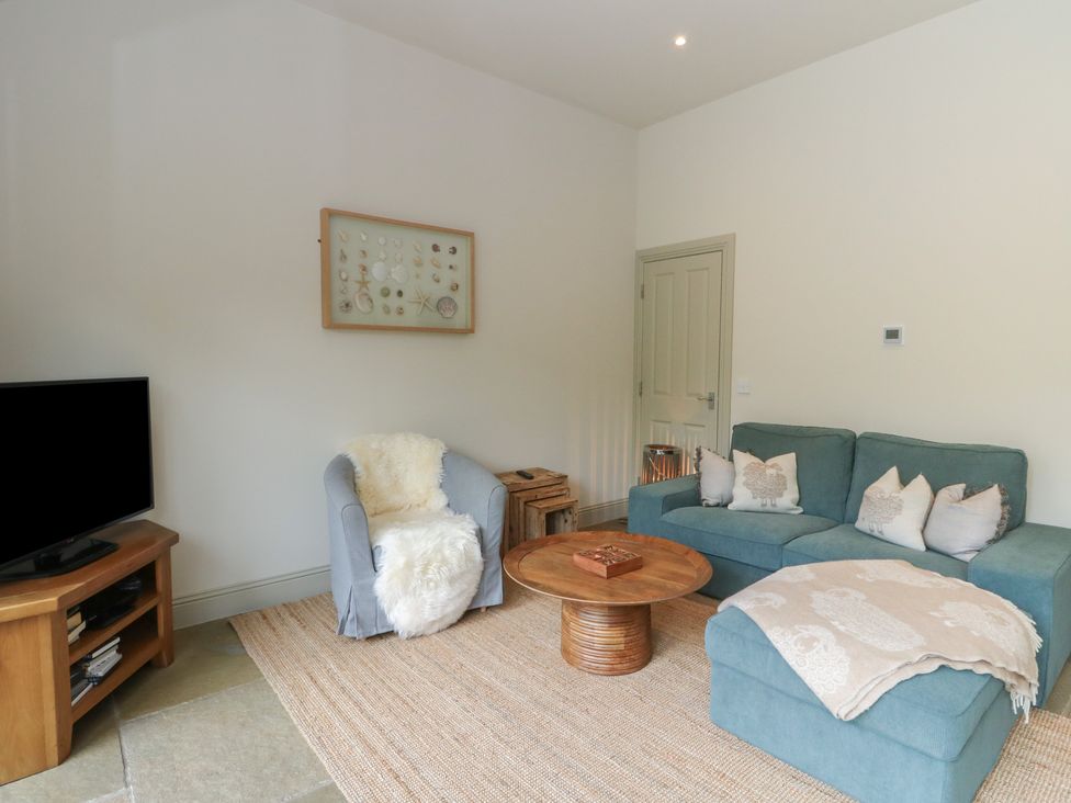 A living room with a sofa and television at Almond in Killin