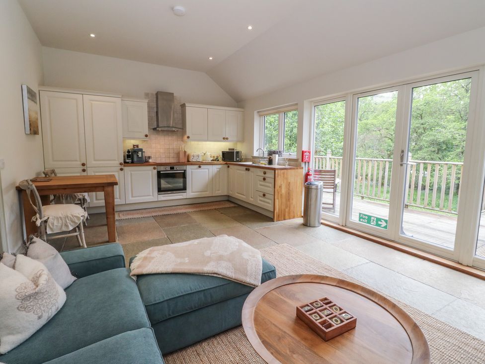 A kitchen with a sofa and dining table at Almond in Killin