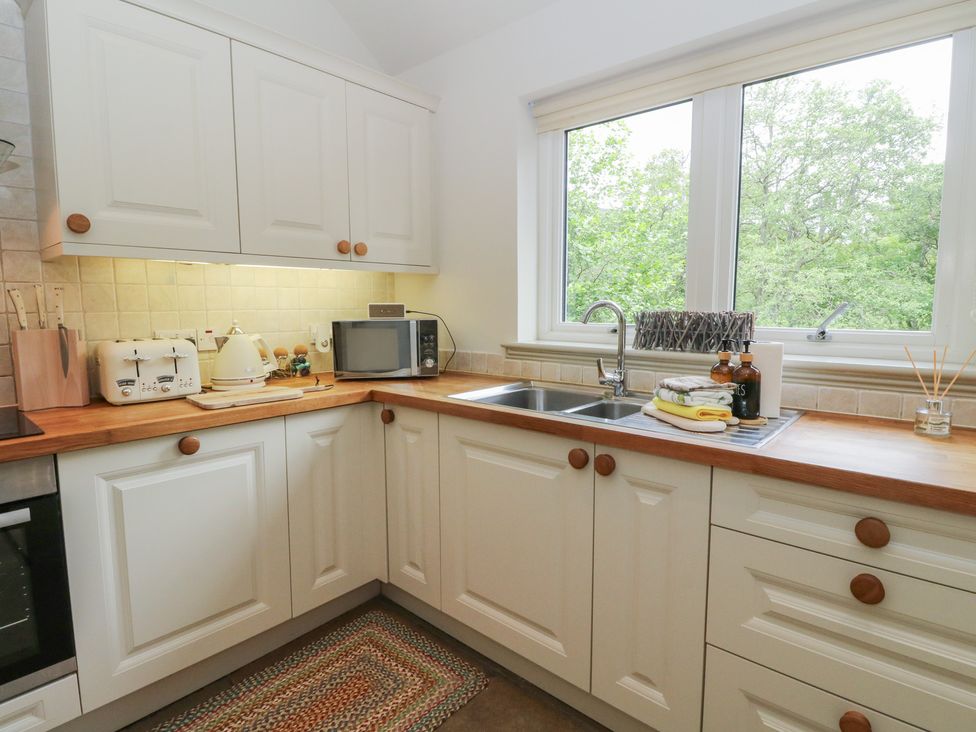 A kitchen with a sink and appliances at Almond in Killin
