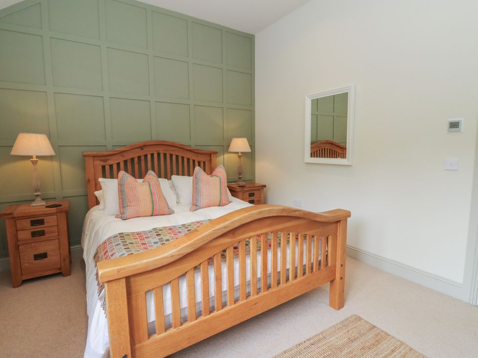 A bedroom with a bed and nightstand at Almond in Killin