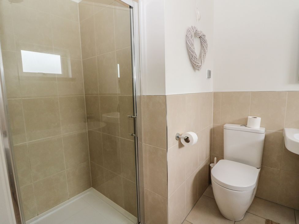 A bathroom featuring a shower, toilet, and sink at Almond in Killin