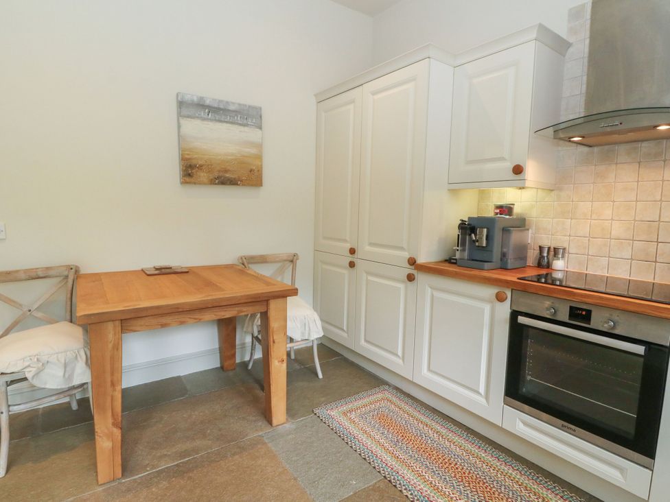 A kitchen with a table and chairs at Garth Cottage in Killin