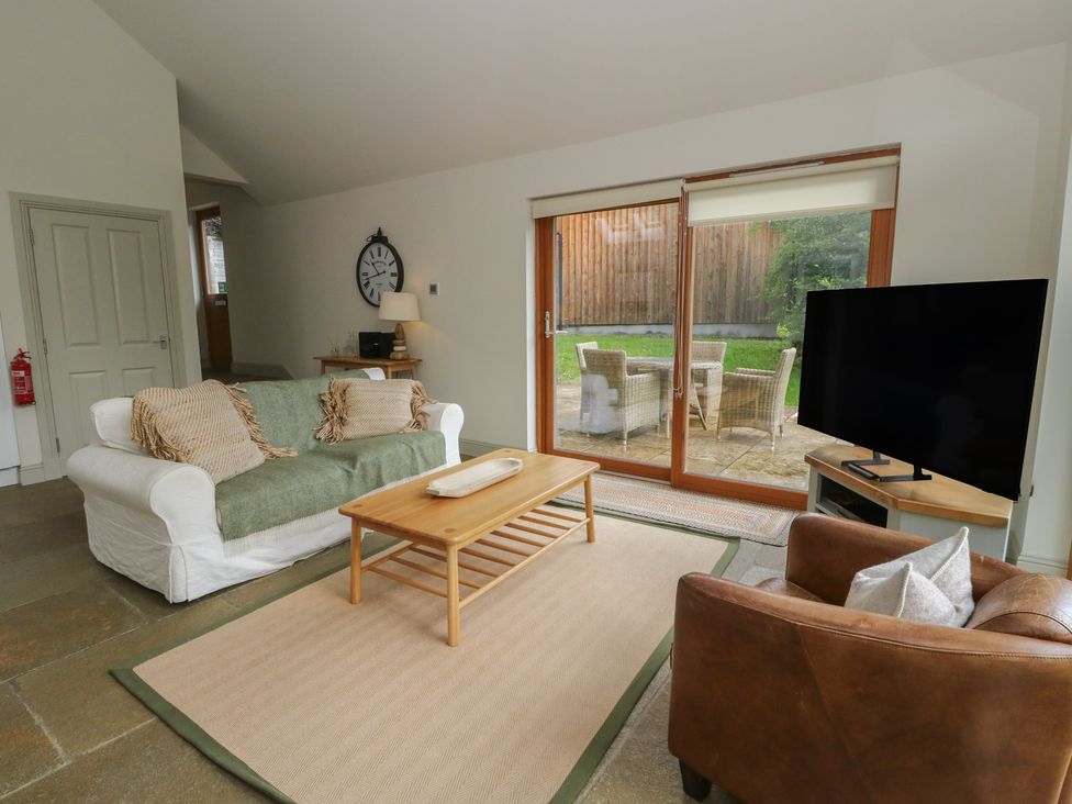 A living room with a sofa and a television at Yew Tree in Killin
