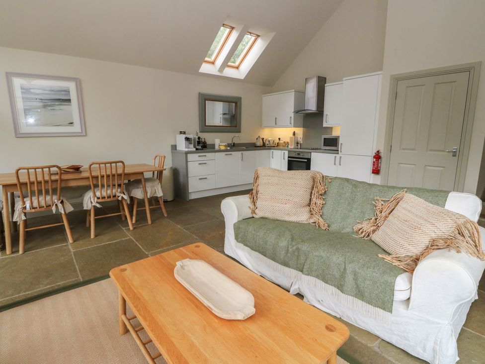 A living room with kitchen and dining area at Yew Tree in Killin