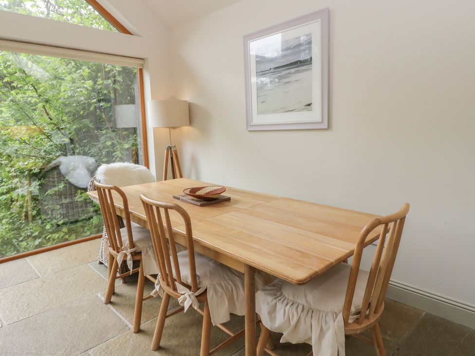A dining room with a wooden table and chairs at Yew Tree in Killin