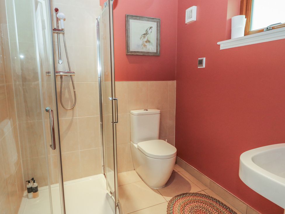 A bathroom with a shower, toilet, and sink at Yew Tree in Killin